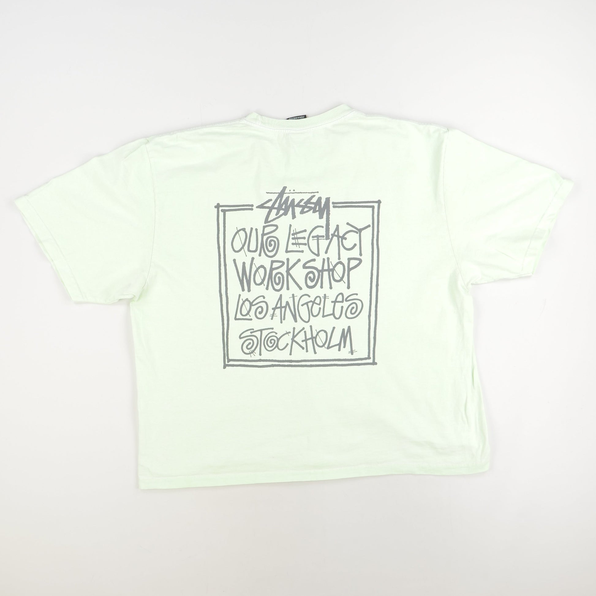 Light green t-shirt with black text on a white background